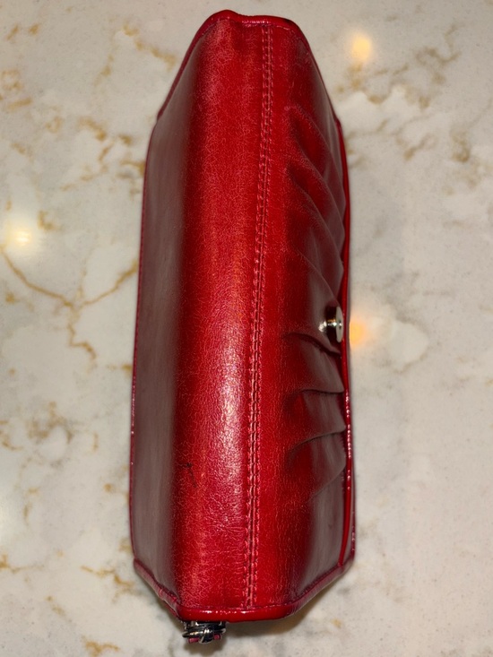 Brighton Red leather wallet featuring a decorative silver-toned snap closure. - Picture 2 of 16